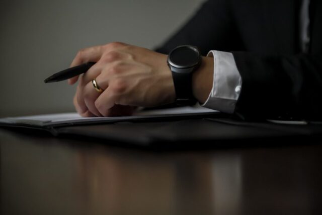 man writing document