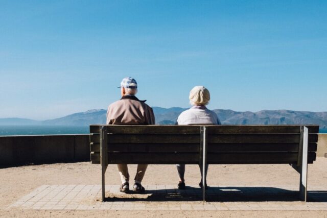 older couple sitting on bench