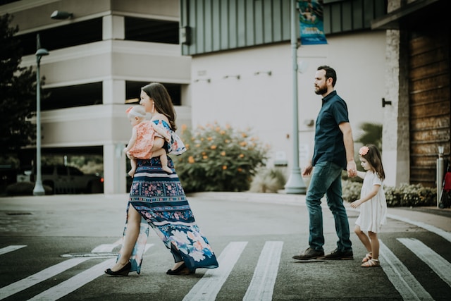 family walking across street