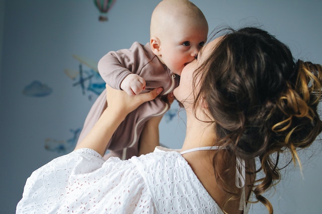 mother holding baby