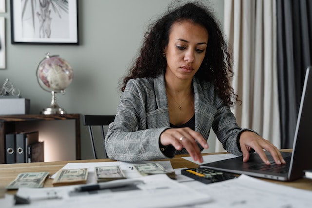woman at computer calculating money