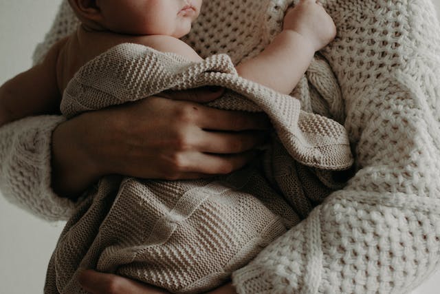 parent holding child in arms