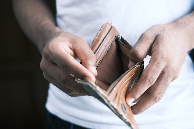 man holding empty wallet