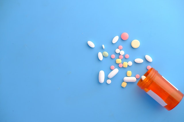 pills spilling out onto blue background