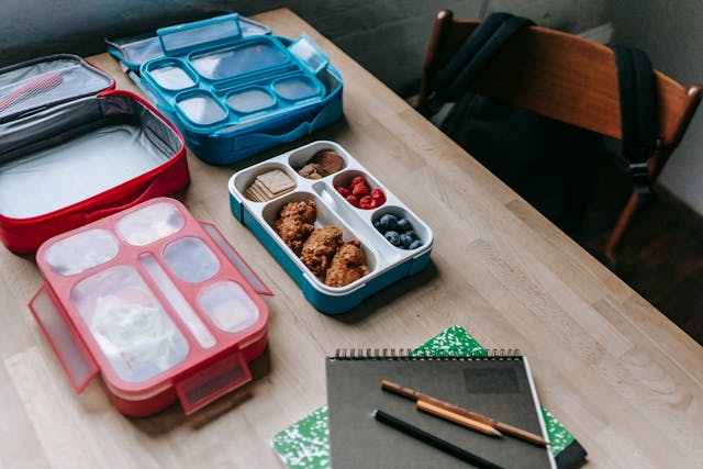 table with lunch boxes and school supplies