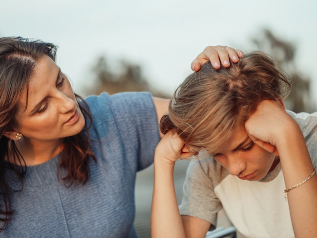 mother comforting sad child