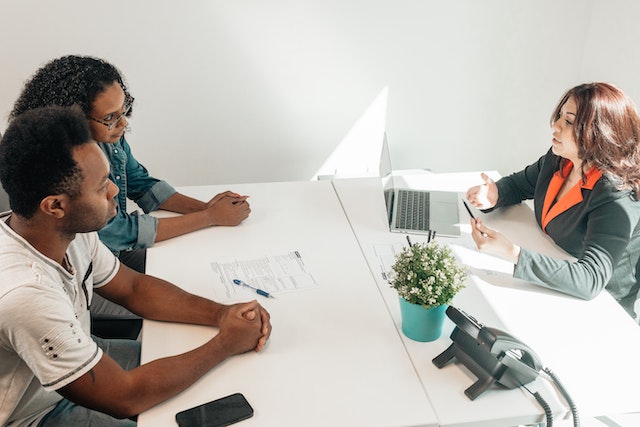 couple talking at table with another person