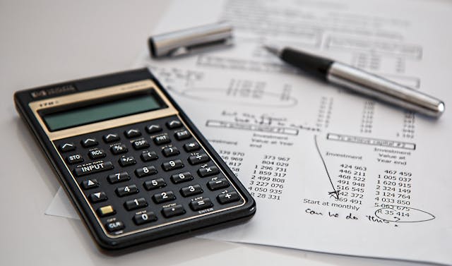 calculator pen and papers