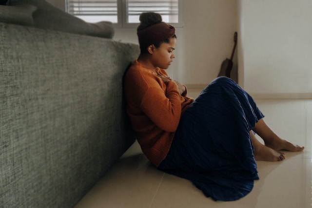 sad woman by couch