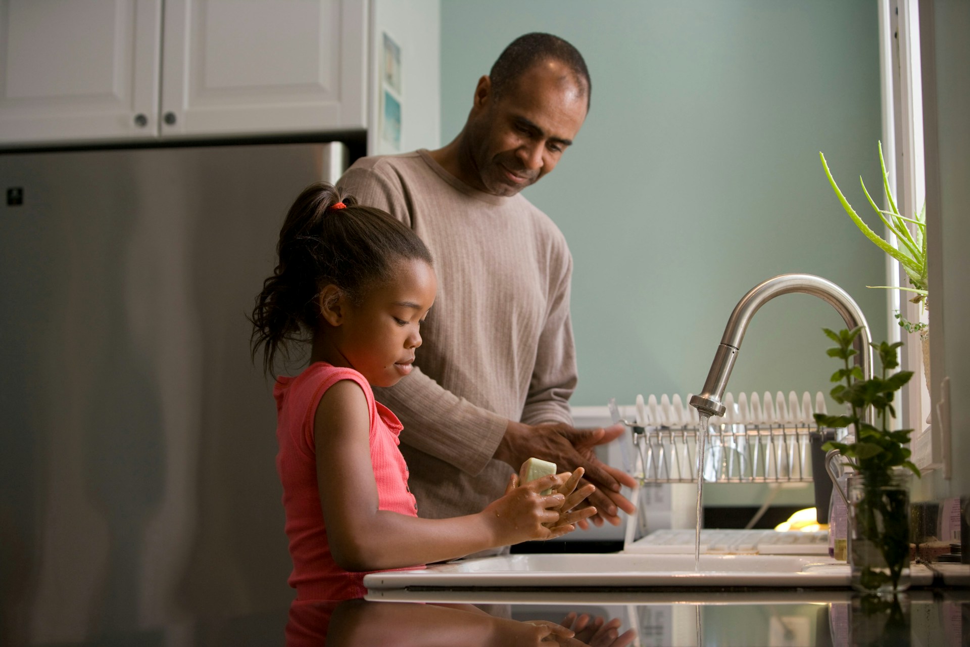 dad and daughter at sink