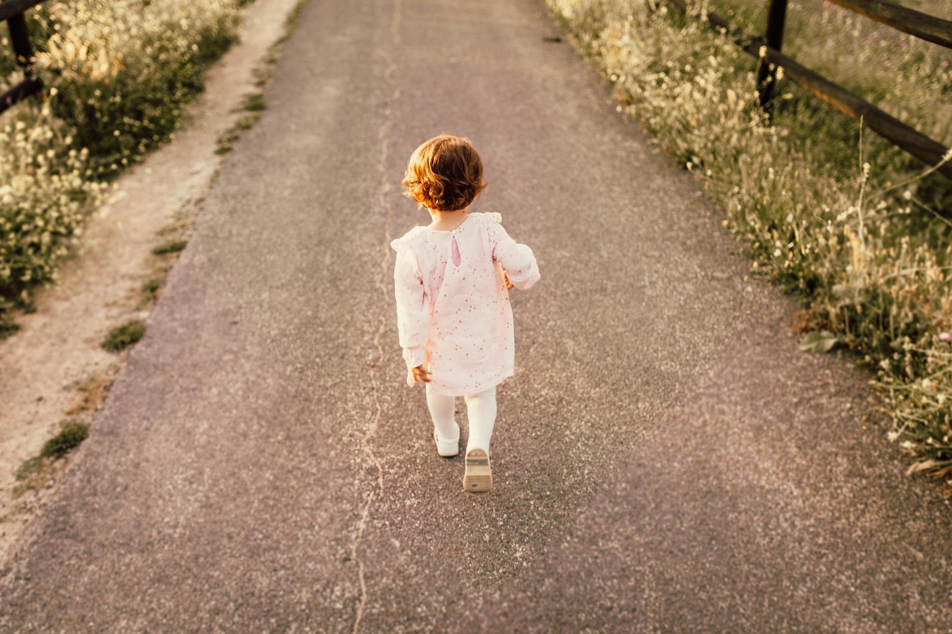 child walking on a road